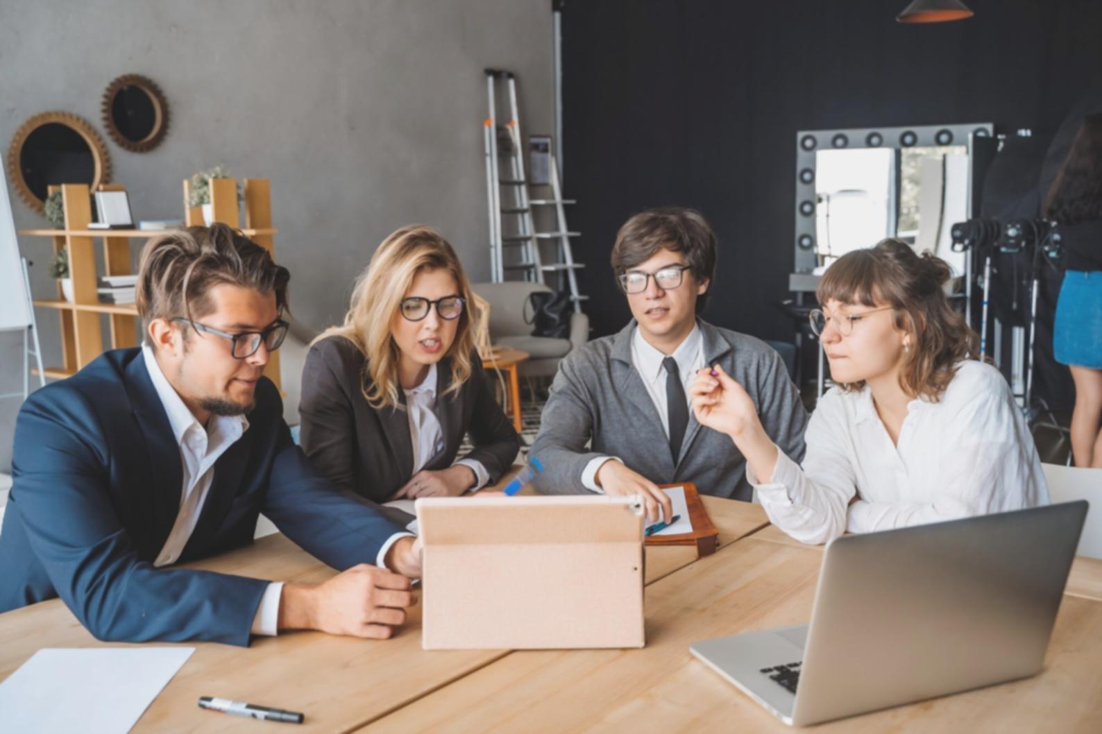 Small business financial planning session with documents and computer